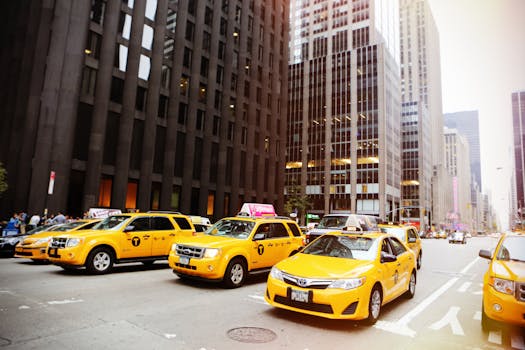 Street scene with yellow taxis in New York City, iconic urban traffic captured in daylight.